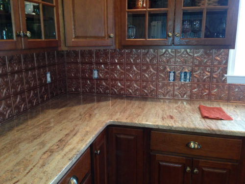 Tin backsplash with copper finish